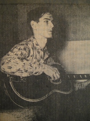 Burns playing guitar.